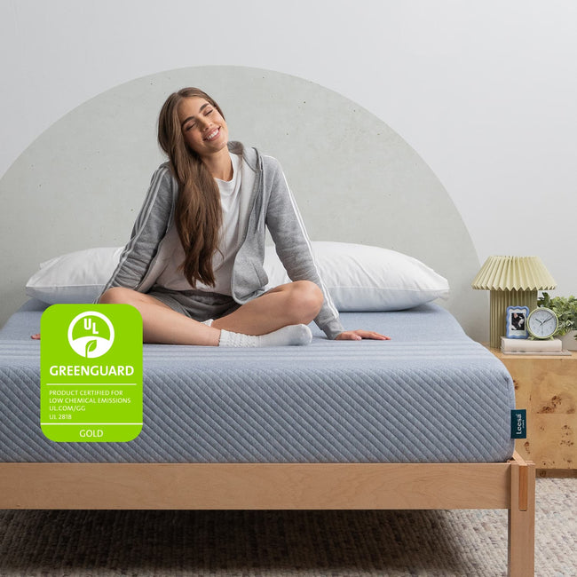 Woman on the Leesa Studio Mattress in a bedroom. for The Mattress Shop, showcasing product thumbnail image for Leesa Studio Mattress on the product page.