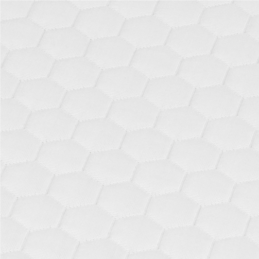 Close-up of white mattress cover with breathable hexagonal quilted fabric texture.